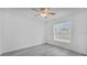 Bright bedroom featuring a window and ceiling fan at 230 Oak Branch Dr, Edgewater, FL 32141