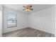Well-lit bedroom with gray flooring and a window at 230 Oak Branch Dr, Edgewater, FL 32141