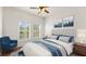 Bedroom with blue chair and ceiling fan at 3810 Wind Dancer Cir, Saint Cloud, FL 34772