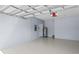 Attached garage with light gray floor and white walls at 3810 Wind Dancer Cir, Saint Cloud, FL 34772