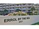 Exterior shot of Errol By The Sea condominiums, boasting balconies, palm trees, and lush landscaping at 4501 S Atlantic Ave # 1150, New Smyrna Beach, FL 32169