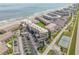 Aerial view of beachfront condos, pool, tennis court, and ample parking at 4811 Saxon Dr # C102, New Smyrna Beach, FL 32169