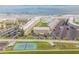 Aerial view of oceanfront condos, tennis court and parking at 4811 Saxon Dr # C102, New Smyrna Beach, FL 32169