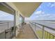 Condo balcony featuring sliding glass doors and seating with scenic ocean views at 4811 Saxon Dr # C102, New Smyrna Beach, FL 32169