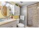 Bathroom featuring granite countertop, tiled shower, and decor accents at 4811 Saxon Dr # C102, New Smyrna Beach, FL 32169