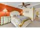 Main bedroom features colorful bedding, palm tree accents, and tray ceiling at 4811 Saxon Dr # C102, New Smyrna Beach, FL 32169