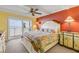 Bedroom featuring colorful bedding, ocean view, and palm tree accents at 4811 Saxon Dr # C102, New Smyrna Beach, FL 32169