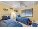 Bedroom featuring two twin beds with blue bedding and fish-themed decor at 4811 Saxon Dr # C102, New Smyrna Beach, FL 32169