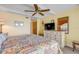 Bedroom featuring a patterned bed, ceiling fan, and dresser with mirror at 4811 Saxon Dr # C102, New Smyrna Beach, FL 32169