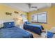 Bedroom with twin beds, ocean view from window, and coastal themed decor at 4811 Saxon Dr # C102, New Smyrna Beach, FL 32169