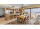 Dining area with views of the beach through the sliding glass doors and adjacent kitchen at 4811 Saxon Dr # C102, New Smyrna Beach, FL 32169