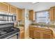 Kitchen featuring stainless steel oven and microwave, and a window with beach view at 4811 Saxon Dr # C102, New Smyrna Beach, FL 32169
