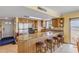 Kitchen featuring stainless steel appliances, stone countertops, breakfast bar with seating, and beach view at 4811 Saxon Dr # C102, New Smyrna Beach, FL 32169
