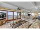 Spacious living room with floor to ceiling beach views, sliding glass doors, and comfortable floral sofa at 4811 Saxon Dr # C102, New Smyrna Beach, FL 32169