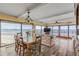 Inviting living room showcasing ocean views, floral sofa, and wood dining set at 4811 Saxon Dr # C102, New Smyrna Beach, FL 32169