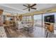 Living room featuring beach view through sliding glass doors, ceiling fan, and a view into the kitchen at 4811 Saxon Dr # C102, New Smyrna Beach, FL 32169