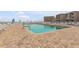 Resort pool and patio, with sun loungers and a distant ocean view at 4811 Saxon Dr # C102, New Smyrna Beach, FL 32169