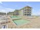 Resort-style pool and hot tub area with lounge seating and ocean view, ideal for vacationing or relaxing at 4811 Saxon Dr # C102, New Smyrna Beach, FL 32169