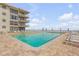 Resort pool with sun loungers and clear blue water, with ocean view at 4811 Saxon Dr # C102, New Smyrna Beach, FL 32169