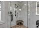 Spacious walk-in shower features black fixtures, a wooden bench and tiled walls at 4946 Halifax Dr, Port Orange, FL 32127