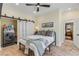 Comfortable bedroom with ample lighting, decorative pillows, and attached laundry room at 4946 Halifax Dr, Port Orange, FL 32127