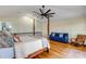 Bright bedroom featuring hardwood floors, a blue sofa, and a four poster bed at 4946 Halifax Dr, Port Orange, FL 32127