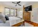 Spacious bedroom featuring a four poster bed, hardwood flooring, and ample lighting at 4946 Halifax Dr, Port Orange, FL 32127