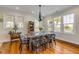 Inviting dining room with a rustic table and chairs, surrounded by ample natural light at 4946 Halifax Dr, Port Orange, FL 32127
