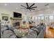 Cozy living room featuring a stone fireplace, hardwood floors, and panoramic water views at 4946 Halifax Dr, Port Orange, FL 32127