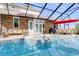 Inviting pool area with a hot tub, comfortable seating, a grill, and an outdoor dining area at 4946 Halifax Dr, Port Orange, FL 32127