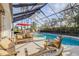 Relaxing screened pool area with comfortable seating and spa at 4946 Halifax Dr, Port Orange, FL 32127