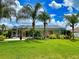 Green backyard, screened pool and palm trees at 6812 Stoneheath Ln, Port Orange, FL 32128