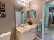 Bright bathroom with a sink, mirror, and toilet at 6812 Stoneheath Ln, Port Orange, FL 32128