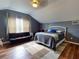 Cozy bedroom with a bed, couch, and window at 6812 Stoneheath Ln, Port Orange, FL 32128