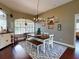 Charming dining room features hardwood floors and a rustic farmhouse table at 6812 Stoneheath Ln, Port Orange, FL 32128