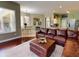 Open living area featuring a brown leather sectional and area rug at 6812 Stoneheath Ln, Port Orange, FL 32128