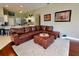 Living room with brown leather sectional and ottoman at 6812 Stoneheath Ln, Port Orange, FL 32128