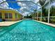 Relaxing screened pool with blue water at 6812 Stoneheath Ln, Port Orange, FL 32128