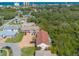 An aerial view displays the property with its brown roof and is surrounded by mature landscaping and trees at 731 Laurel Bay Cir, New Smyrna Beach, FL 32169