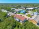 A high aerial view showcases the property with its neighboring townhomes and the surrounding landscape at 731 Laurel Bay Cir, New Smyrna Beach, FL 32169