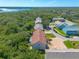 An aerial view of townhomes featuring lush green surroundings, a brick driveway, and lake views at 731 Laurel Bay Cir, New Smyrna Beach, FL 32169
