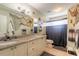 The bathroom features a double vanity, an updated shower and a nautical theme at 731 Laurel Bay Cir, New Smyrna Beach, FL 32169