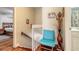 Bright hallway with hardwood floors, a decorative chair, and access to a bedroom and bathroom at 731 Laurel Bay Cir, New Smyrna Beach, FL 32169