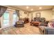 Inviting living room features comfortable seating, wood floors, and sliding doors to a deck at 731 Laurel Bay Cir, New Smyrna Beach, FL 32169