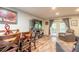 Comfortable living room featuring wood floors, a flat-screen TV, and a cozy seating area with sliding glass doors at 731 Laurel Bay Cir, New Smyrna Beach, FL 32169