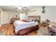 Comfortable main bedroom with wood floors, natural light, and a ceiling fan at 731 Laurel Bay Cir, New Smyrna Beach, FL 32169