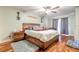 Cozy main bedroom featuring hardwood floors, a ceiling fan, and natural light at 731 Laurel Bay Cir, New Smyrna Beach, FL 32169