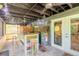 Outdoor patio features wooden bar, string lights, ceiling fans, and glass doors to inside at 731 Laurel Bay Cir, New Smyrna Beach, FL 32169