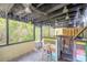 Outdoor patio with wooden bar, string lights, ceiling fans, and lush green views at 731 Laurel Bay Cir, New Smyrna Beach, FL 32169