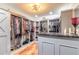 This walk-in closet features custom shelves, hanging racks, and a black countertop for optimal storage at 731 Laurel Bay Cir, New Smyrna Beach, FL 32169